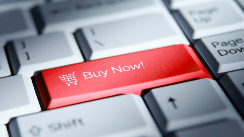 Red 'buy now!' button on a computer keyboard