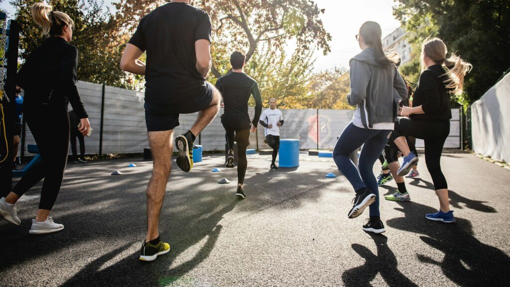 Man in black t-shirt and black shorts running on road during daytime