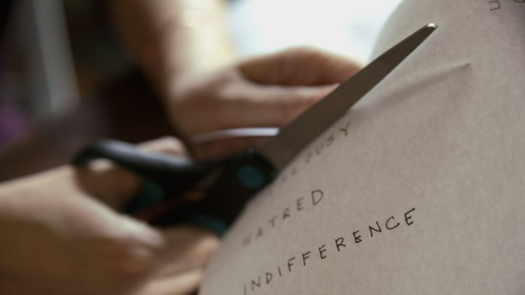 Person cutting piece of paper