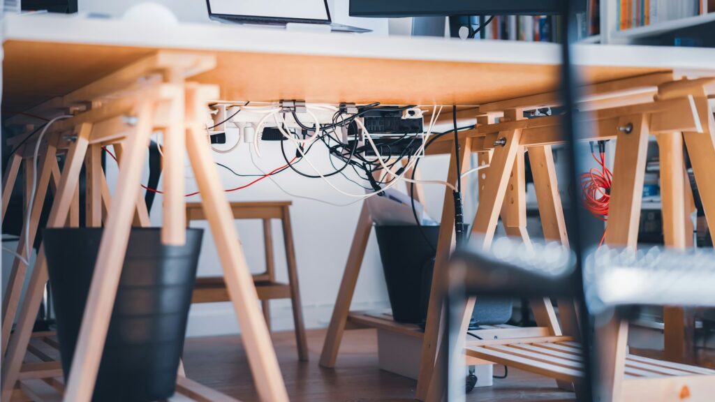 A desk with a laptop on top of it