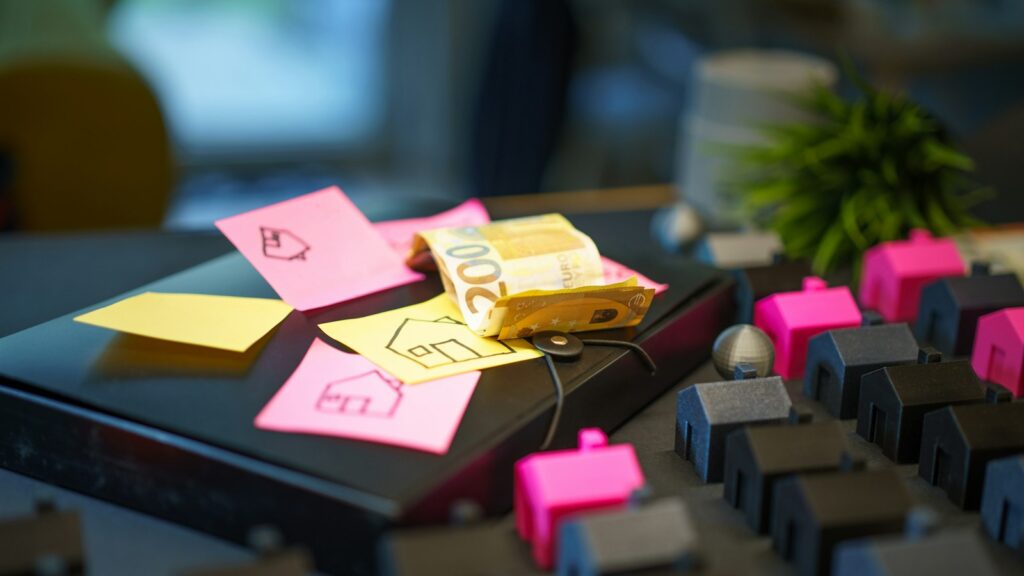Miniature houses and sticky notes with house drawings
