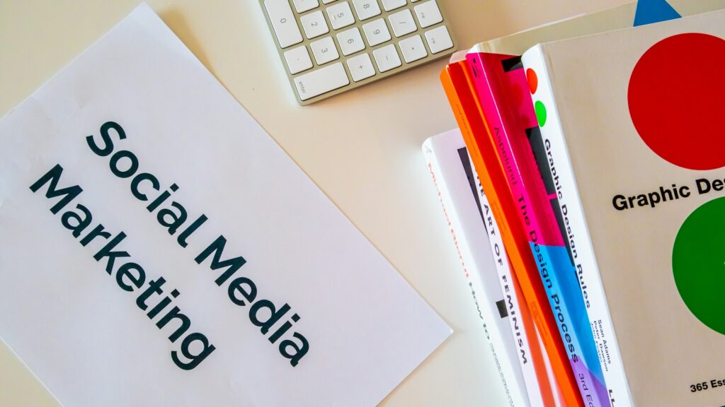 A sign that says social media marketing next to a keyboard