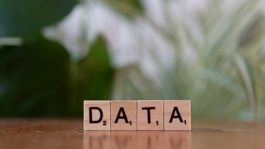 A wooden block spelling data on a table