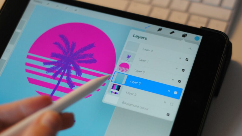 Person holding white pen and black ipad