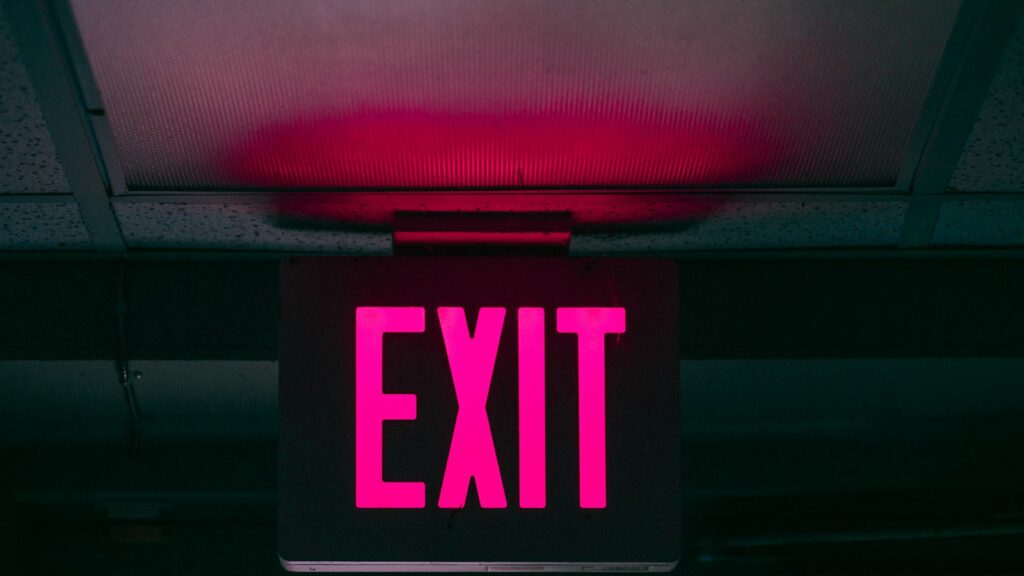 Black and pink Exit signage