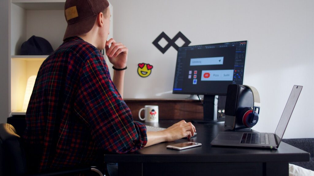 Man sitting near table using computer