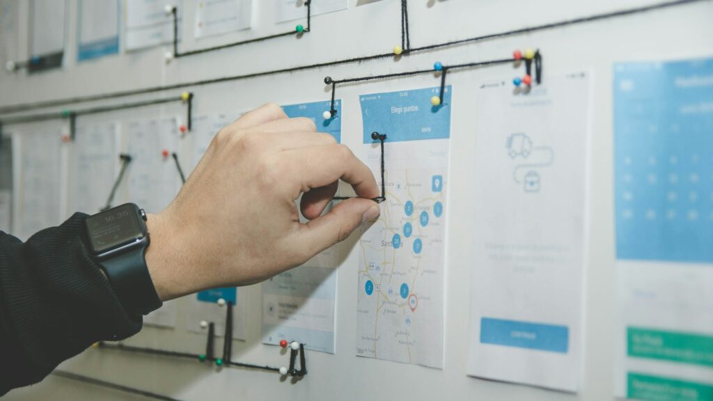 Person working on blue and white paper on board