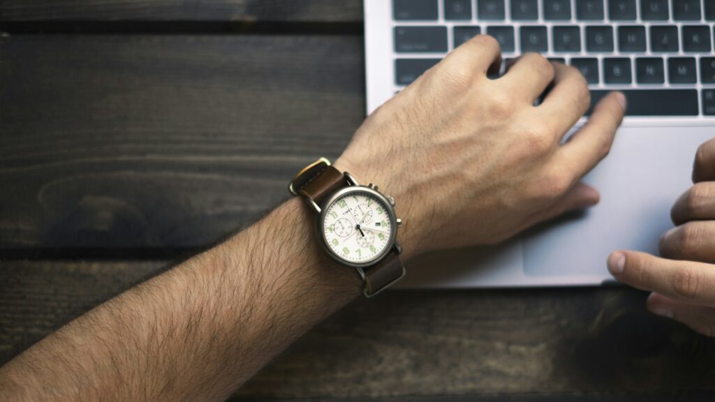 Person wearing brown and white watch