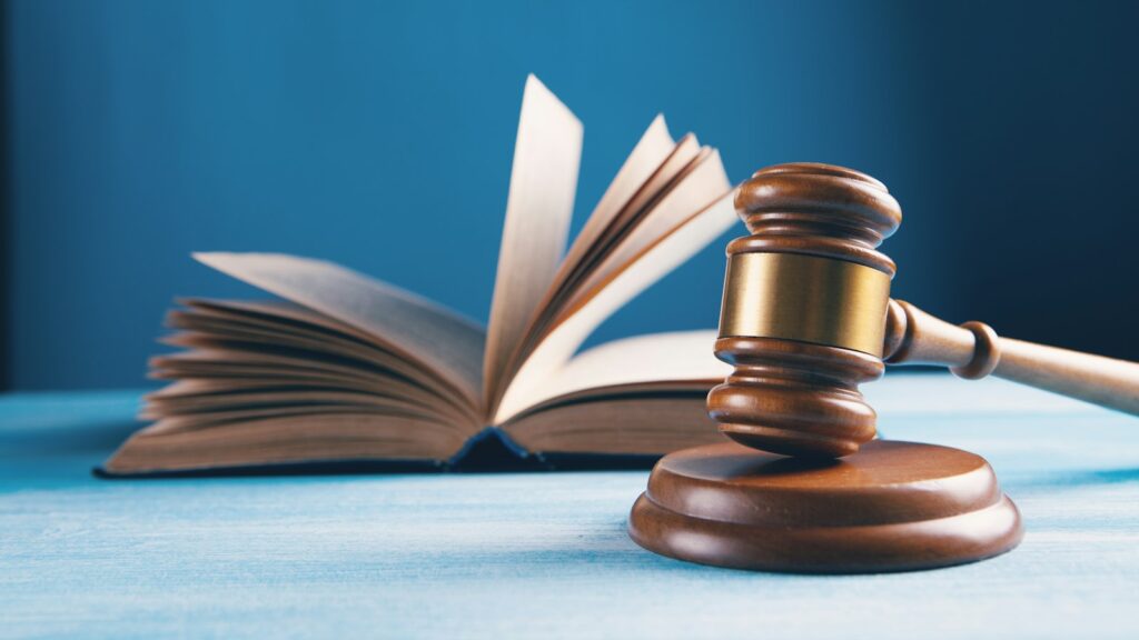 Judges gavel and open book on table