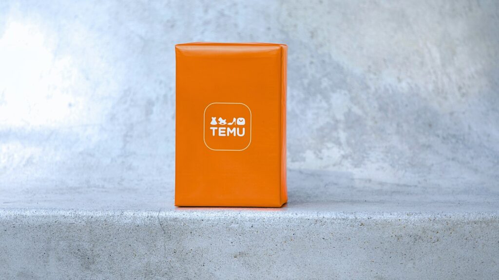 Orange box with white logo on concrete surface