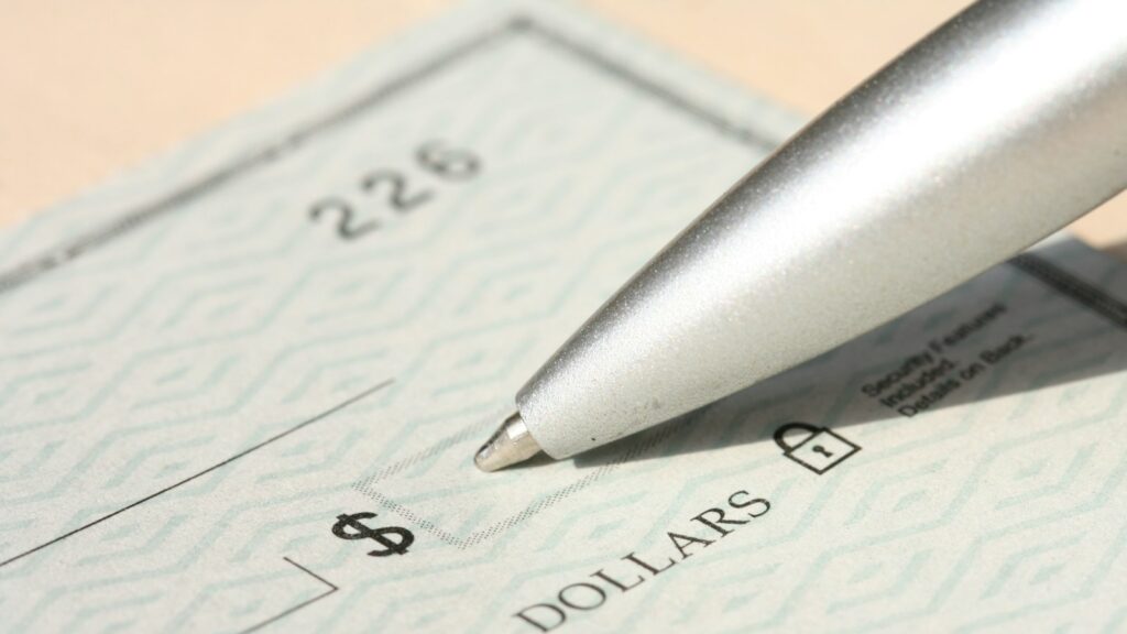 Pen poised over a check, ready to write