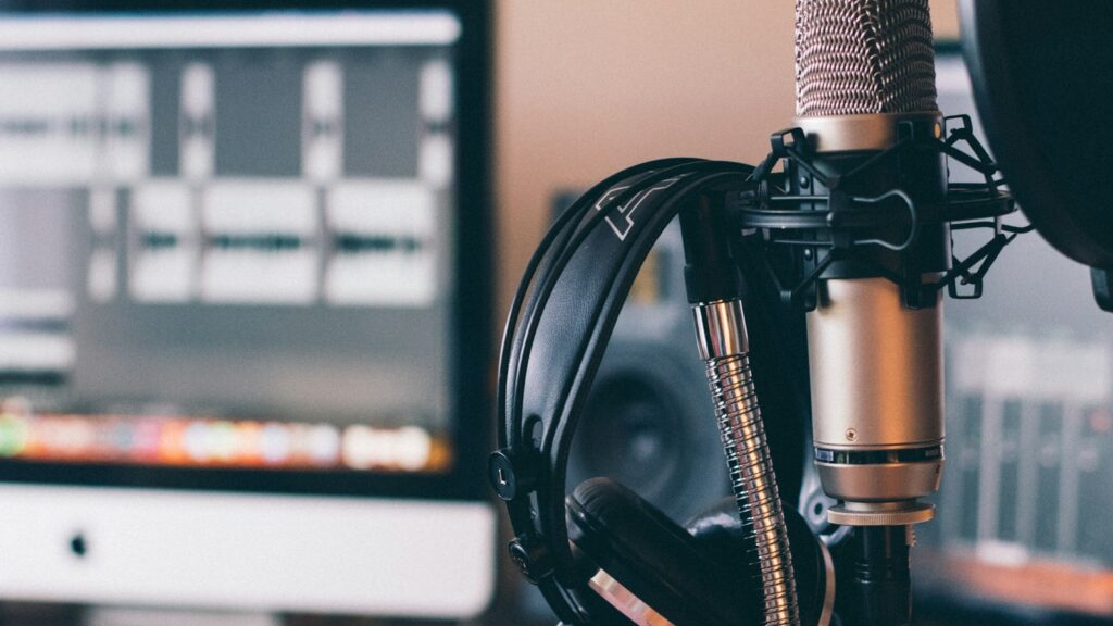 Black and silver headphones on black and silver microphone