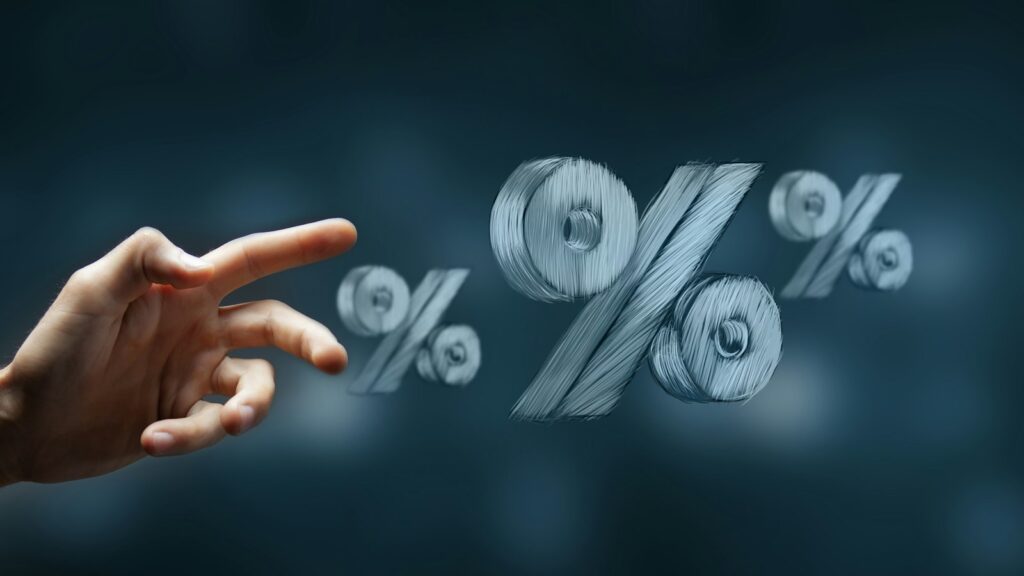 Hand reaching towards floating percentage symbols