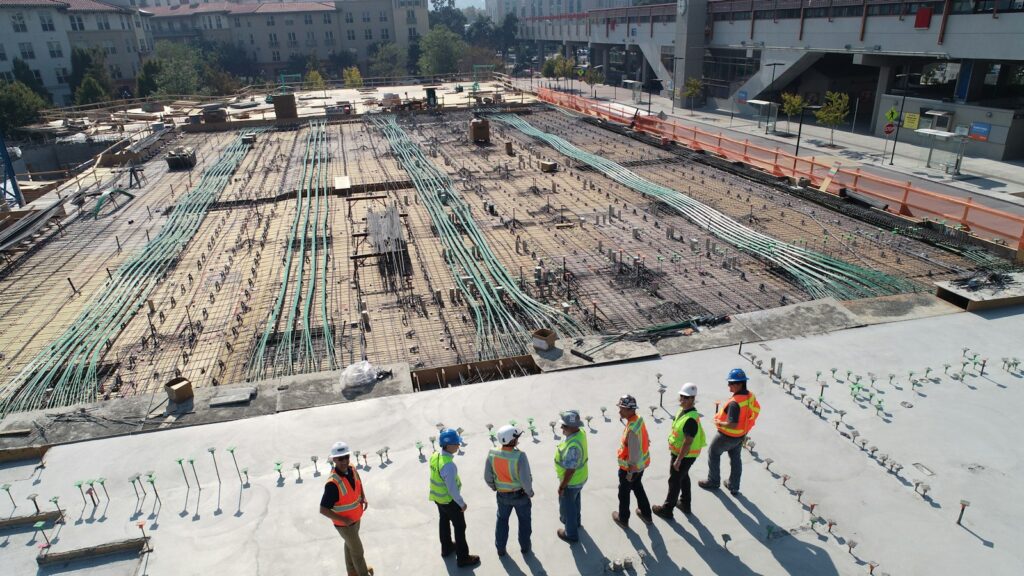 Seven construction workers standing on white field