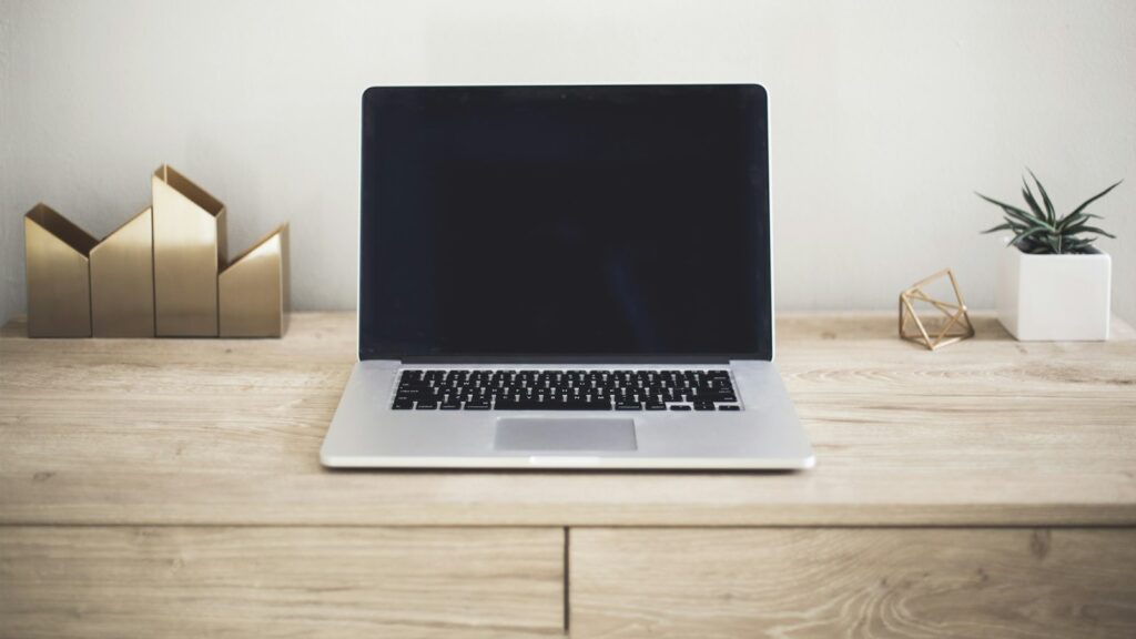 MacBook Pro on top of brown table