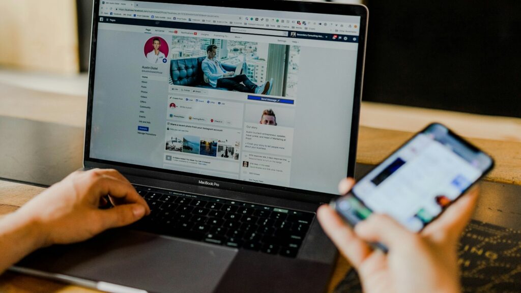 Person using both laptop and smartphone