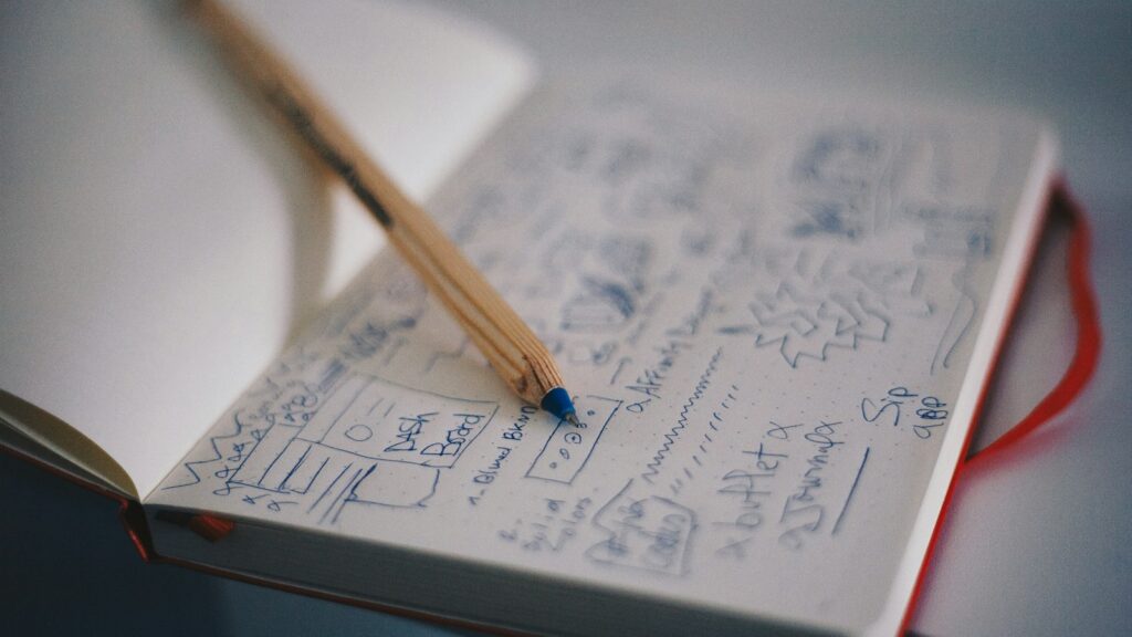 Blue ballpoint pen on white notebook