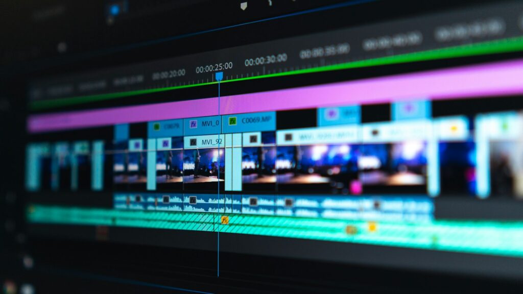 A video editing timeline with blue and purple clips on a dark screen