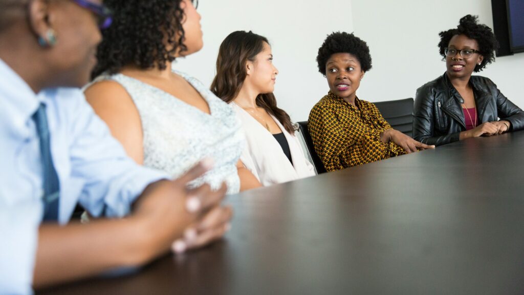 Five people sitting at table and talking