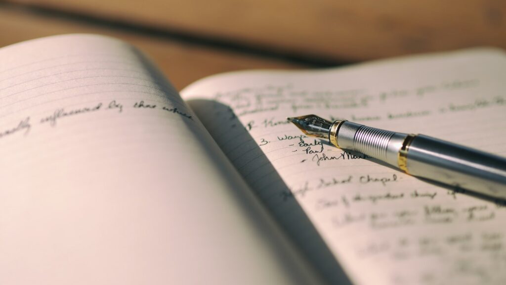 Pen on white lined paper selective focus photography