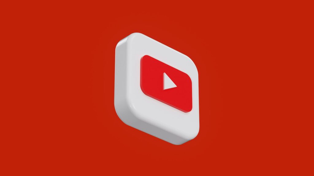 A red and white play button on a red background